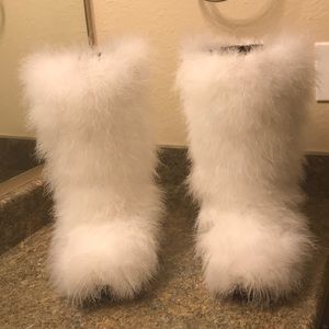 White feathered knee boots.